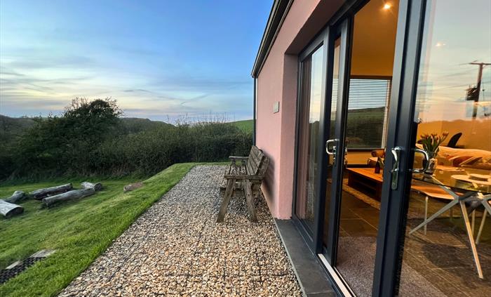 Sliding glass doors of an accommodation block with a bench outside